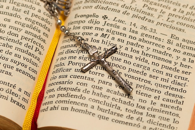 Foto gratuita close-up libro sagrado y collar de cruz
