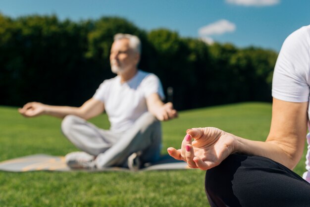 Close-up personas meditando al aire libre