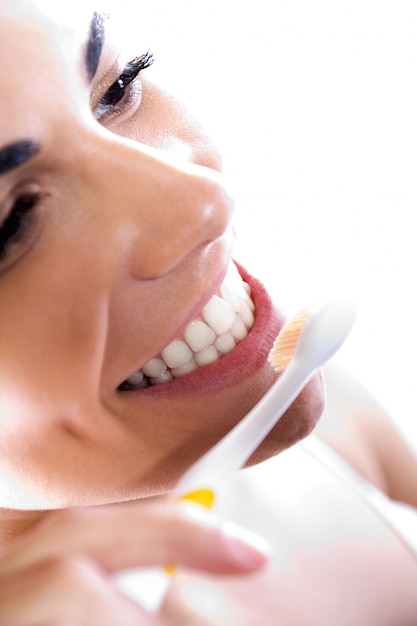 Foto gratuita close up retrato de joven y bella mujer recogiendo sus dientes