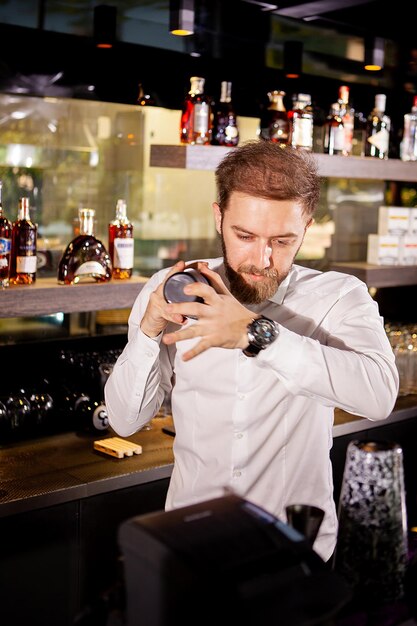 Cóctel de alcohol en la barra. El camarero prepara un cóctel alcohólico. Bebida deliciosa