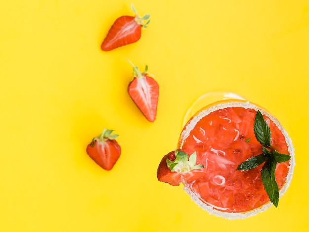 Cóctel frío rojo fresco con fresas, menta y hielo.