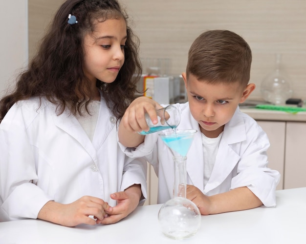 Colegas haciendo un experimento químico en la escuela.