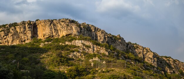 Colina cubierta de vegetación y rocas en el Parque Natural de Arrabida en Setúbal, Portugal