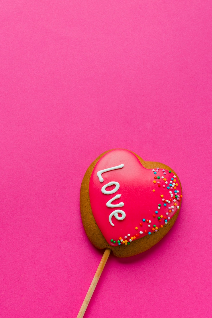 Foto gratuito colocación plana de galleta en forma de corazón en el palo y espacio de copia