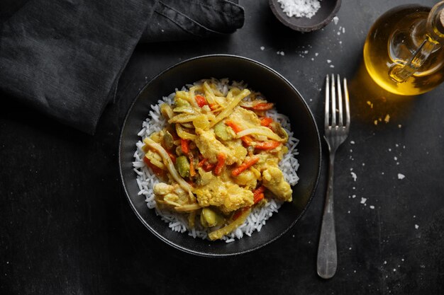 Comida asiática pollo frito con salsa y arroz servido en plato