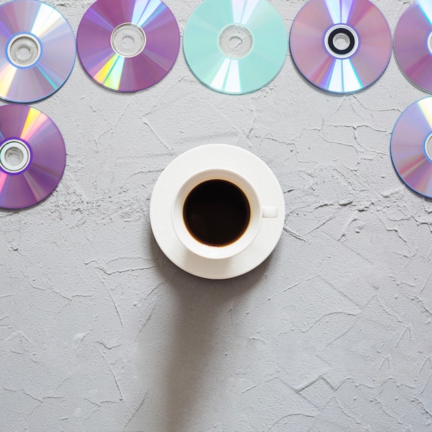 Foto gratuita compacta discos con café