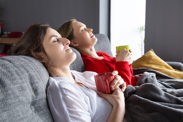 Compañeras de cuarto teniendo frío y descansando en casa.