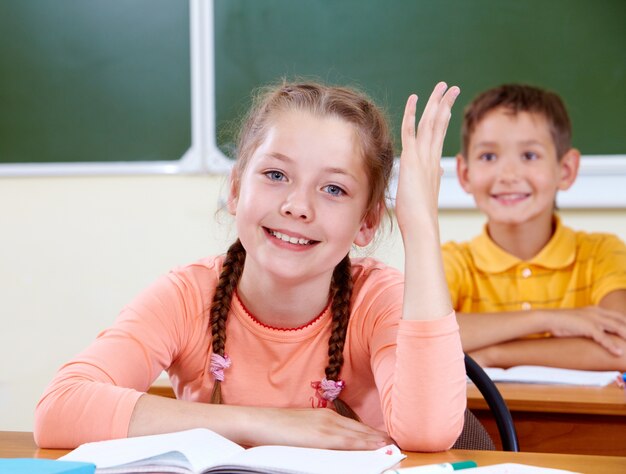 Compañeros de clase sonrientes sentados en el aula