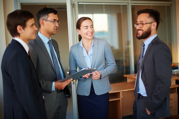 Foto gratuita compañeros de trabajo compartiendo bromas en la oficina