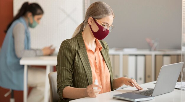 Compañeros de trabajo con mascarilla en el trabajo