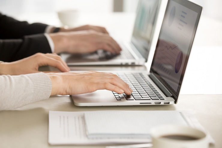 Foto gratuito compañeros de trabajo que trabajan en las computadoras en la oficina