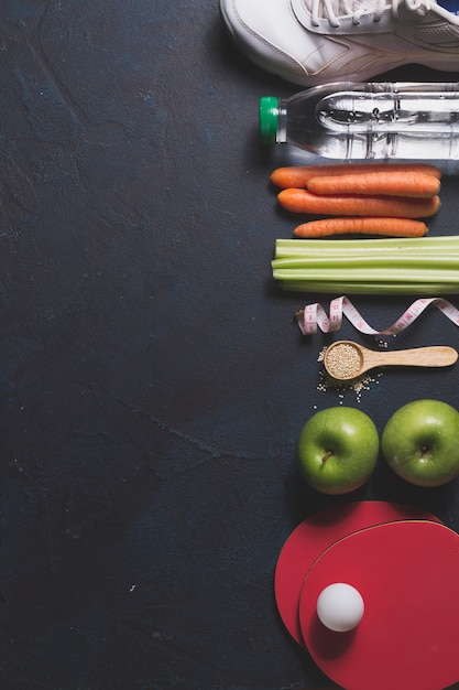 Composición con comida saludables y artículos de deporte