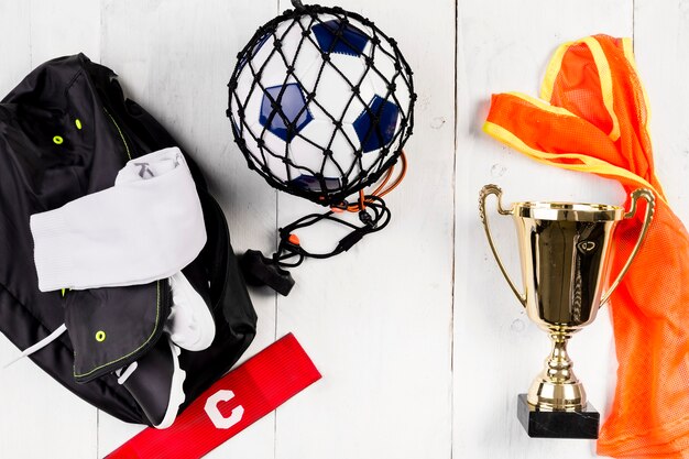 Composición de fútbol con pelota en red y mochila