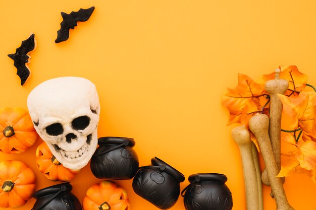 Composición de halloween con teteras y cráneo