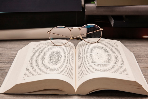 Composición de libros con gafas de lectura en libro