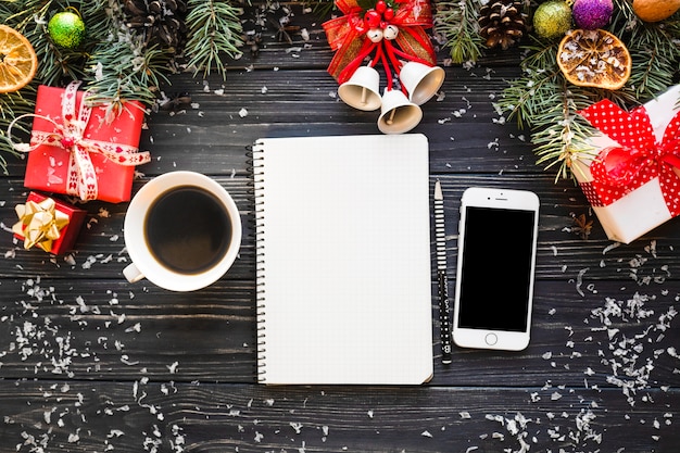 Composición de navidad con libreta y smartphone