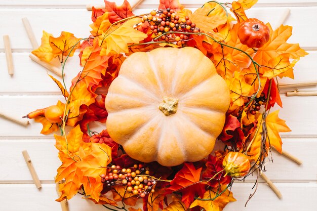 Composición de otoño con calabaza en hojas de otoño