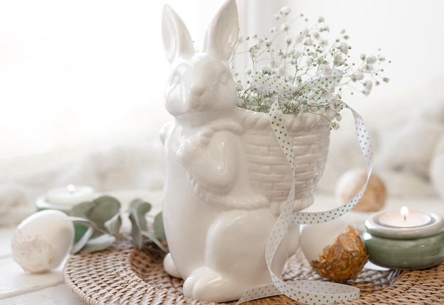 Composición de Pascua con liebre de cerámica y flores de gipsófila