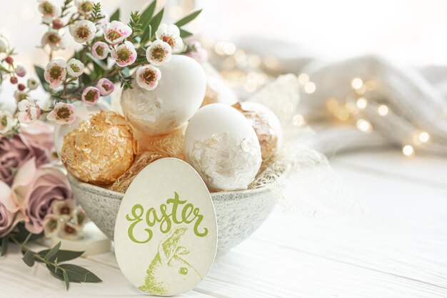 Composición de primavera con huevos de Pascua y flores sobre un fondo borroso