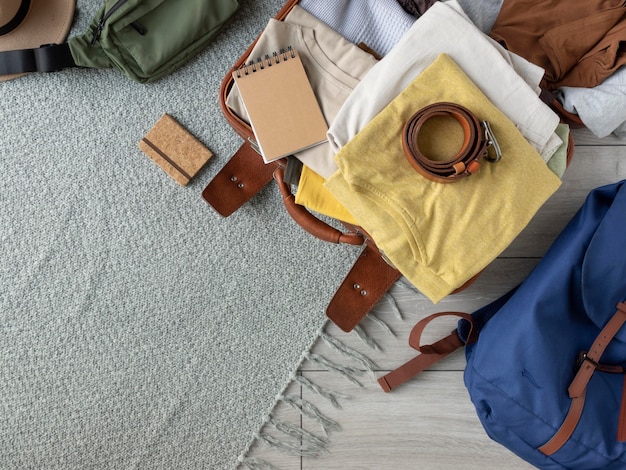 Composición de ropa y accesorios en una maleta.