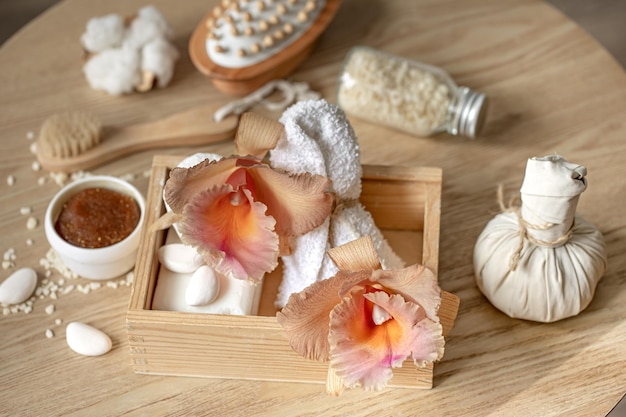 Composición de spa con flores de orquídeas tailandesas y accesorios de baño.