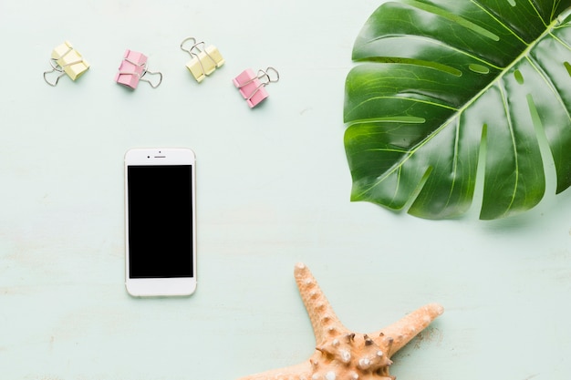 Foto gratuita composición de vacaciones de playa con teléfono sobre fondo claro