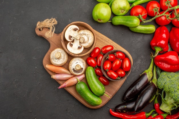 Foto gratuita composición de verduras frescas de vista superior sobre el fondo oscuro