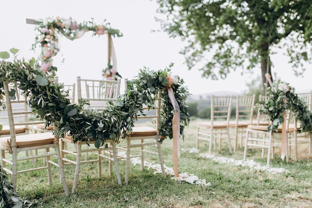 Composiciones florales hechas de vegetación en la ceremonia de boda al aire libre