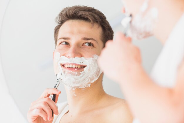 Concepto de afeitar con hombre atractivo joven