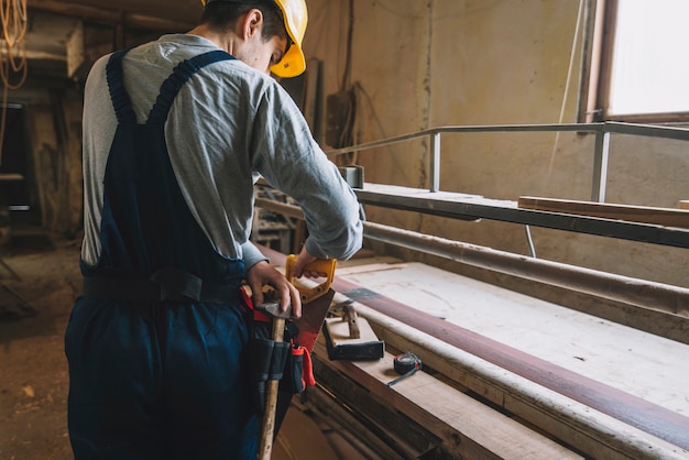 Concepto de carpintería con hombre trabajando en madera