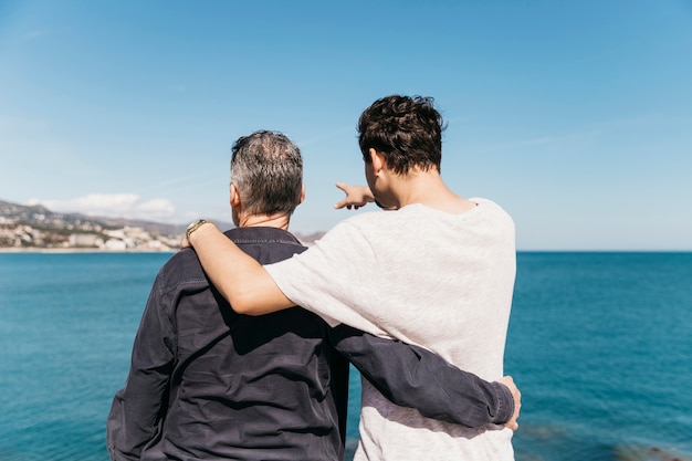 Concepto del día del padre con padre e hijo enfrente del mar