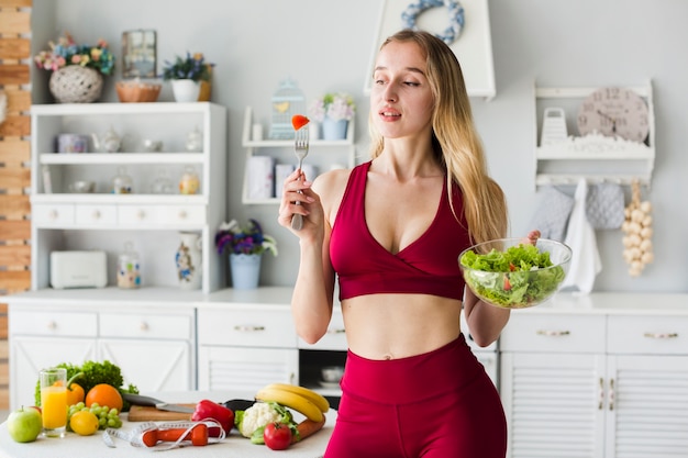 Concepto de dieta con mujer deportiva en la cocina