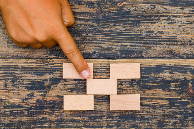 Concepto de estrategia empresarial sobre fondo de madera plana lay. dedo ponderando al bloque de madera.