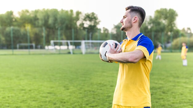 Concepto de fútbol de amateur con hombre posando con pelota