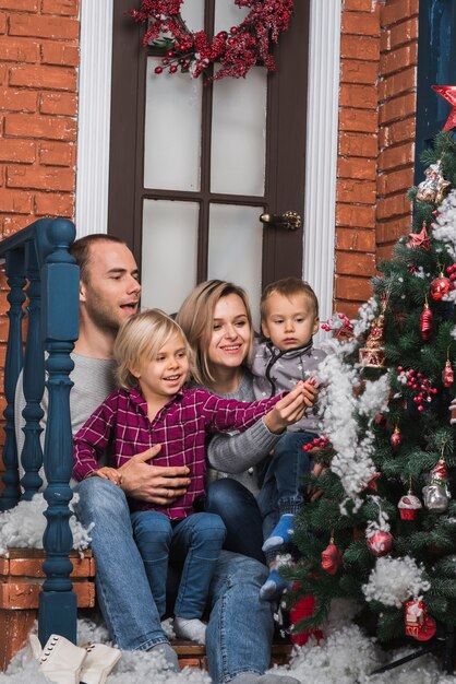 Concepto de navidad con familia sentada fuera