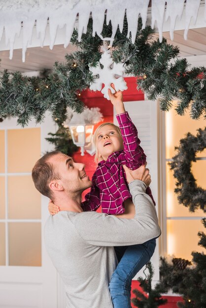Concepto de navidad con padre sujetando hija