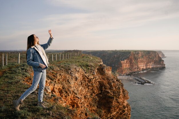 Concepto de pasión por los viajes con mujer joven disfrutando de la naturaleza que la rodea