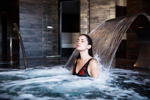 Concepto de spa con mujer relajando en agua