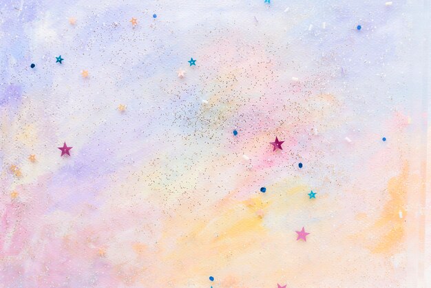 Confeti estrella brillante sobre fondo acuarela pastel abstracto colorido