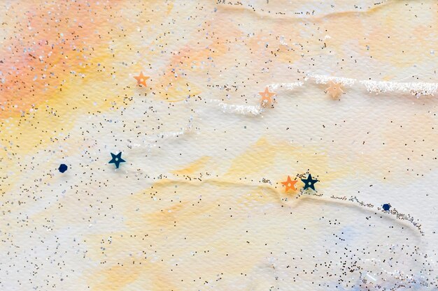Confeti estrella reluciente sobre fondo acuarela pastel abstracto colorido