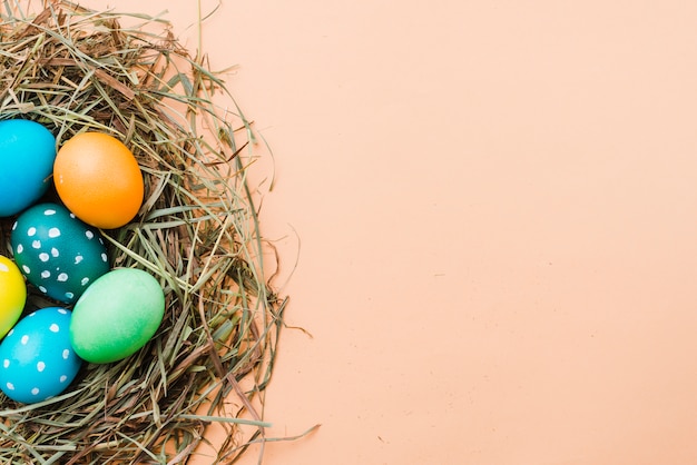 Foto gratuita conjunto de huevos de pascua brillantes en nido