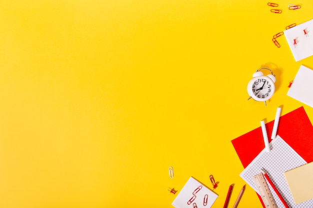 Conjunto de papelería escolar brillante en pared naranja