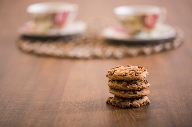 Foto gratuita cookies y tazas de café borrosos