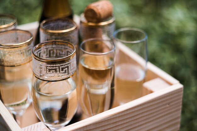 Copas de champán en cajón de madera al aire libre