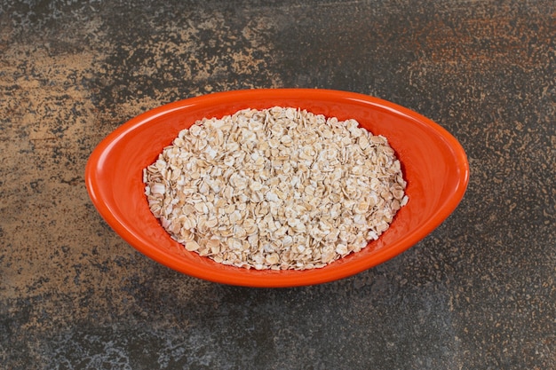 Copos de avena sabrosos en un tazón de naranja.