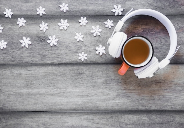 Copos de nieve cerca de auriculares y té