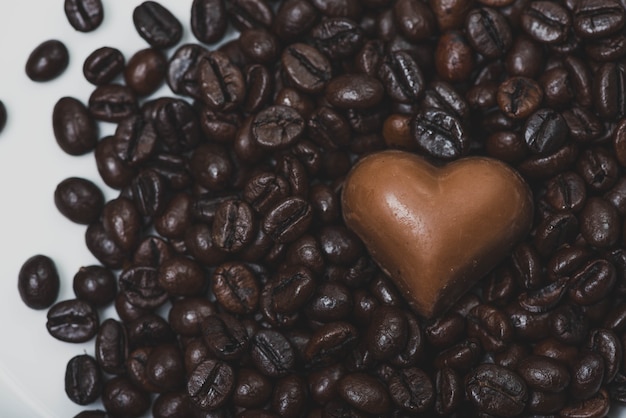 Corazón de chocolate sobre granos de café