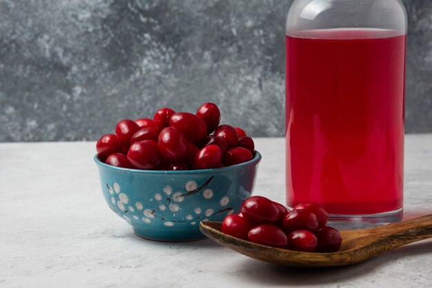 Cornelas rojas y una jarra de bebida.