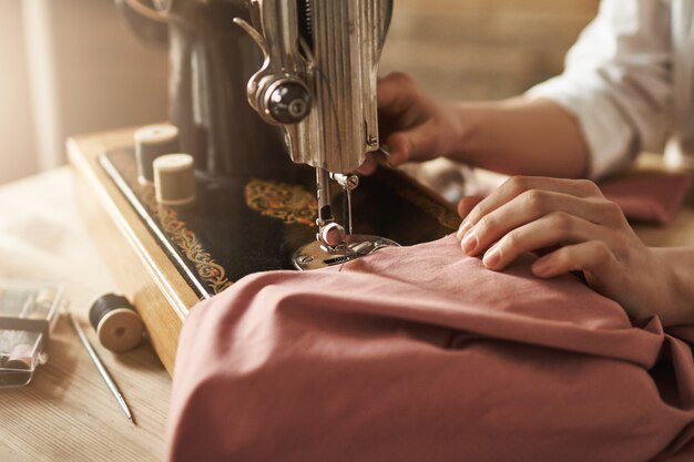 Coser mantiene mi mente relajada. Captura recortada de sastre femenina trabajando en un nuevo proyecto, haciendo ropa con máquina de coser en el taller, estando ocupada. Joven diseñadora que hace realidad sus ideas