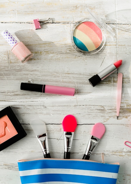 Cosméticos cerca de la bolsa de maquillaje con aplicadores